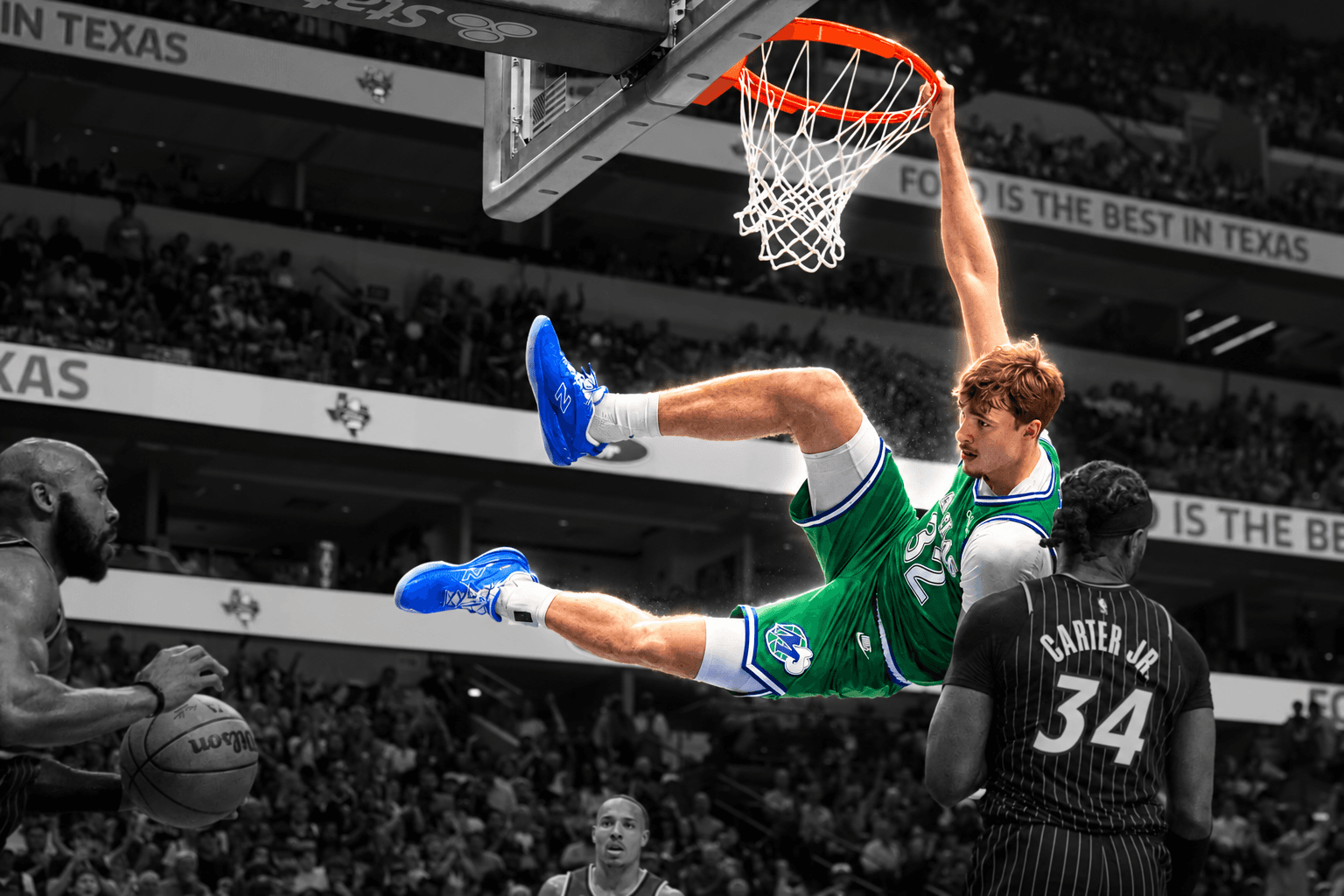 Basketball player hanging from the rim after a dunk